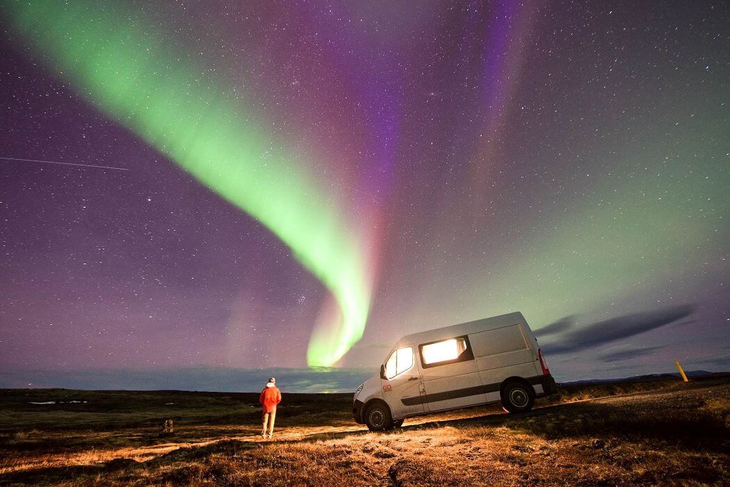 Aurora in the sky above a camper van from GoCamper