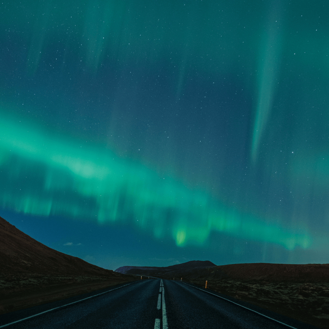 Northern light above a straight road 