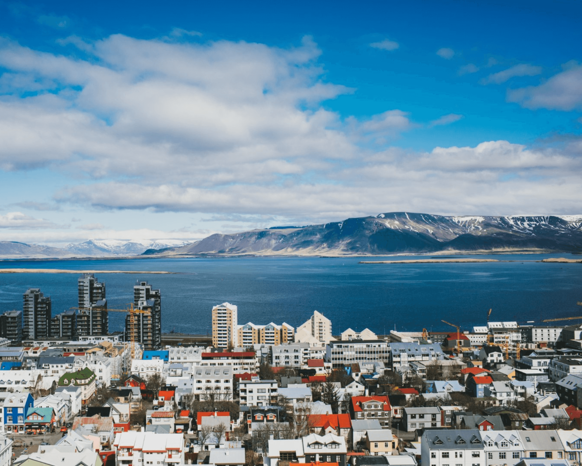 Panoramic Beauty: Reykjavik Enveloped by Majestic Mountains